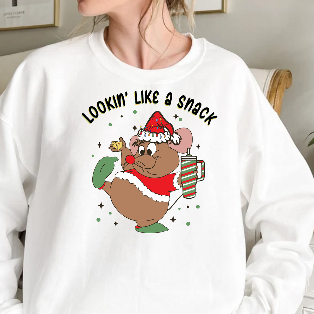 Person wearing a white sweatshirt with a Christmas-themed graphic design.