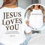 White t-shirt with 'Jesus Loves You' text worn by a person, with a close-up inset.