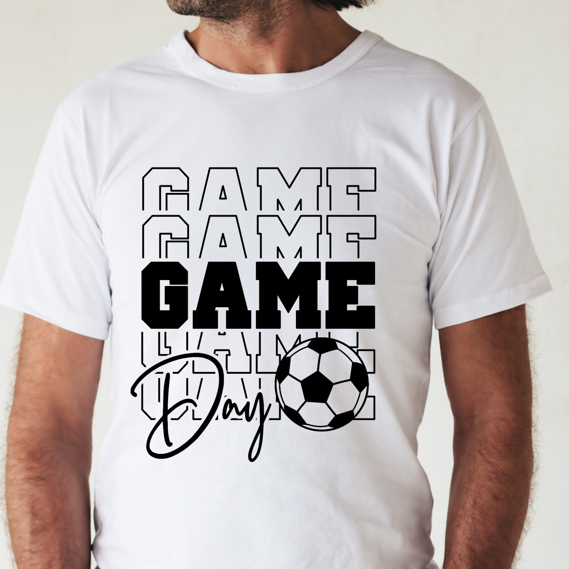 White t-shirt with 'GAME GAME GAME Day' text and soccer ball graphic on a plain background