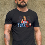 Man wearing a black t-shirt with a graphic design against a textured wall.