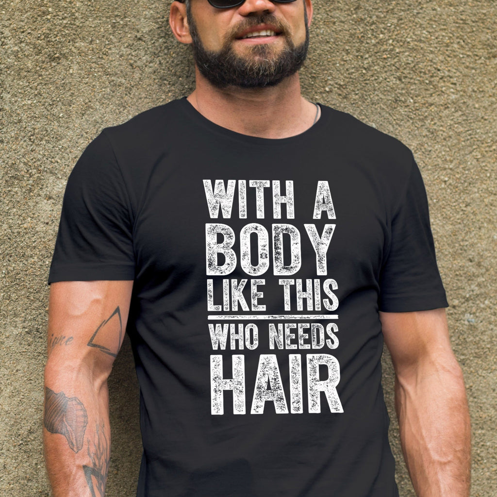 Man wearing a black t-shirt with text and sunglasses, standing against a textured wall.