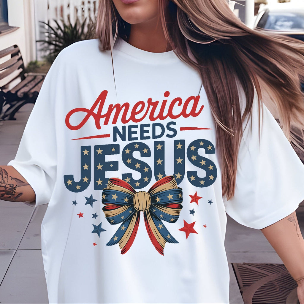 Person wearing a white t-shirt with 'America Needs Jesus' design outdoors.
