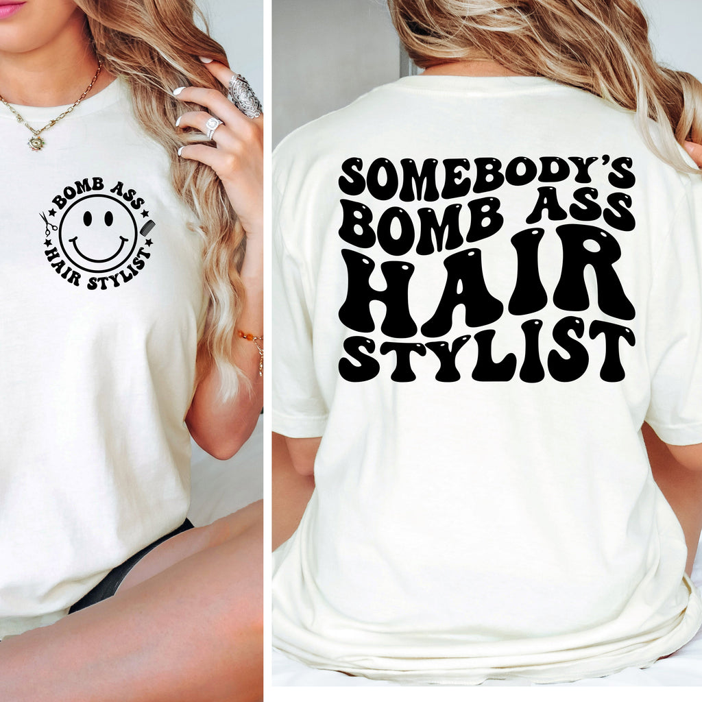 White t-shirt with smiley face design on front and text on back, worn by a person.