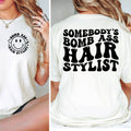 White t-shirt with smiley face design on front and text on back, worn by a person.