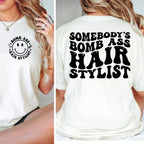 White t-shirt with smiley face design on front and text on back, worn by a person.