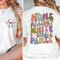 White t-shirt with cartoon character on front and colorful text on back