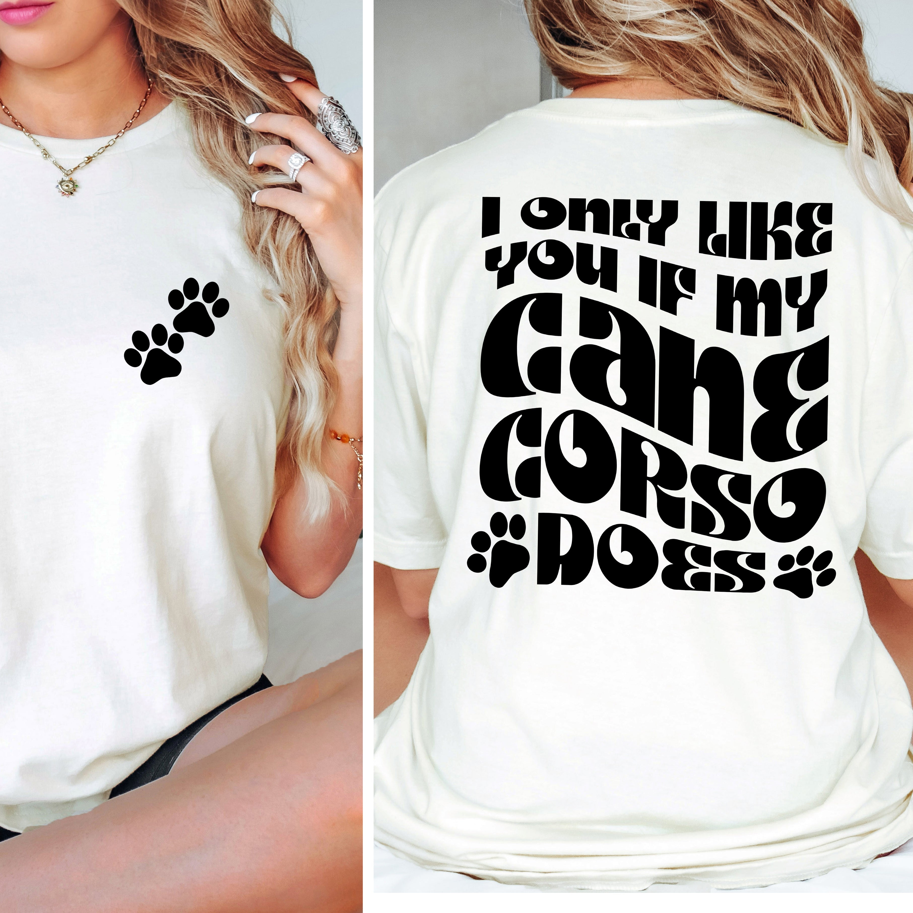 White t-shirt with paw print design on front and text on back, worn by a person.