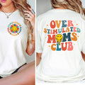 White t-shirt with colorful 'Overstimulated Moms Club' design on front and back, worn by a person.