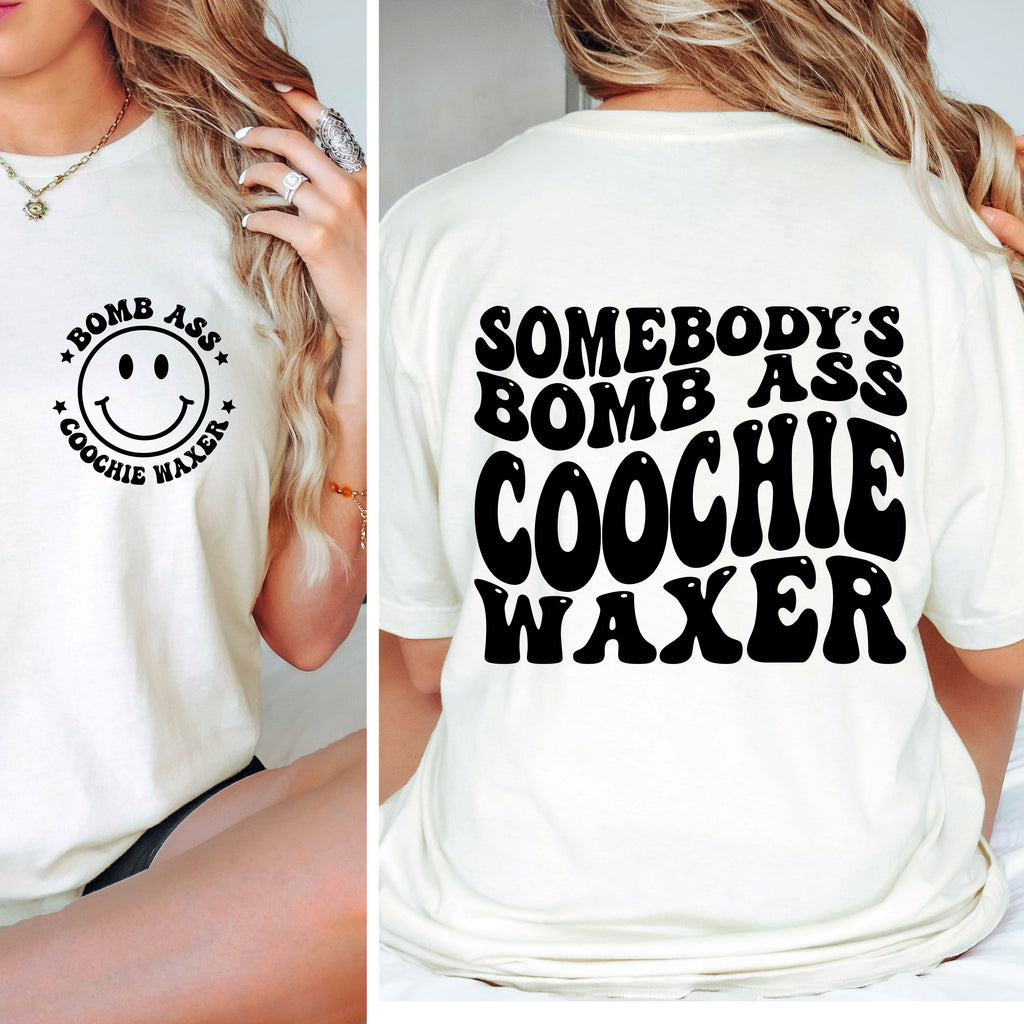 White t-shirt with smiley face and text on front and back, worn by a person.