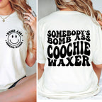 White t-shirt with smiley face and text on front and back, worn by a person.