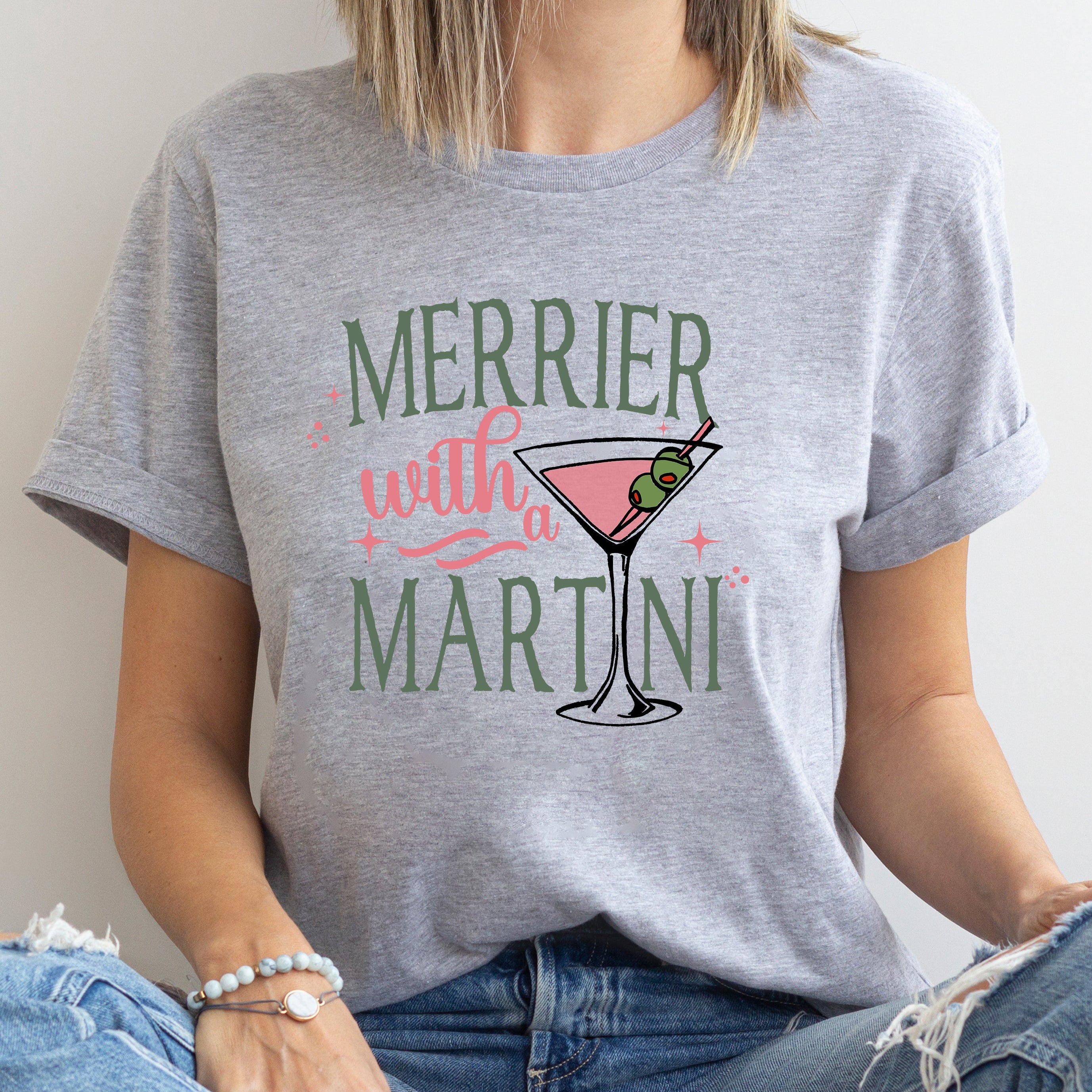 Person wearing a gray t-shirt with a martini graphic and text.